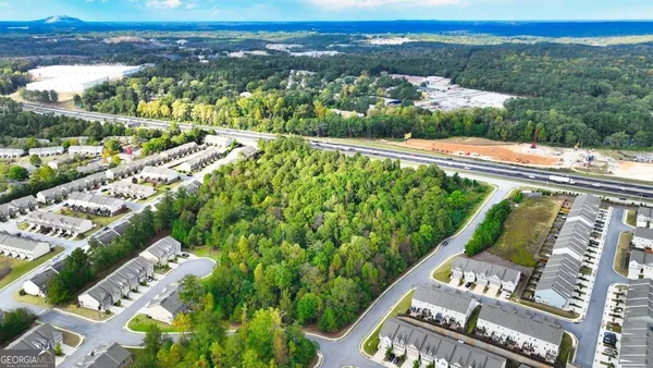 a view of a swimming pool with a patio and a garden