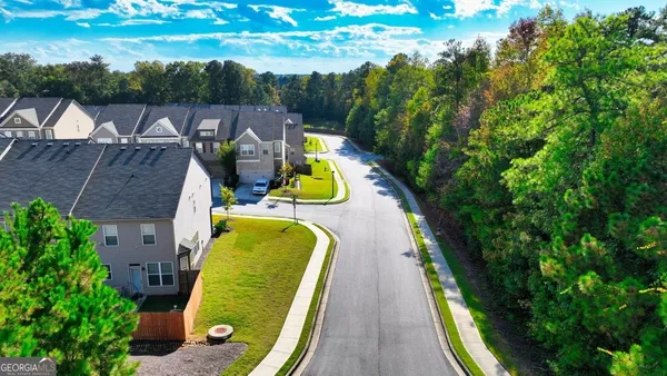 a view of swimming pool with a garden and deck