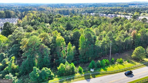 an aerial view of lake residential houses with outdoor space and trees