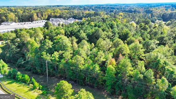 a backyard of a house with lots of green space and a fountain