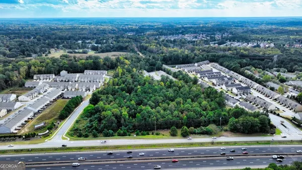 an aerial view of a house with a yard and lake view