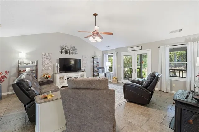 a kitchen with stainless steel appliances granite countertop a sink dishwasher a stove and white cabinets with wooden floor