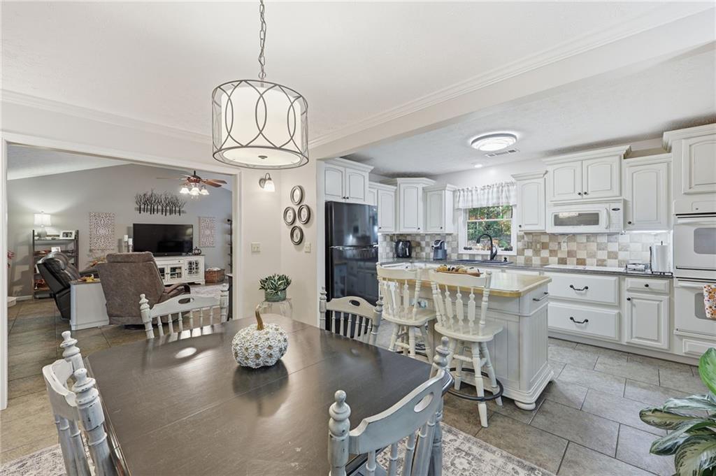 136 Ross Road Mineral Bluff, GA 30559 - Photo 16 of 65 a kitchen with stainless steel appliances granite countertop a stove refrigerator dining table and chairs
