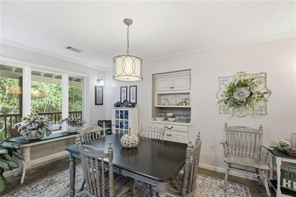136 Ross Road Mineral Bluff, GA 30559 - Photo 20 of 68 a view of a dining room and livingroom with furniture wooden floor a chandelier