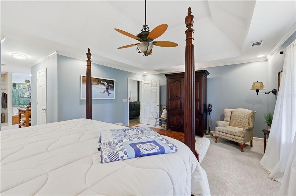 136 Ross Road Mineral Bluff, GA 30559 - Photo 20 of 65 a bedroom with a bed and a chandelier