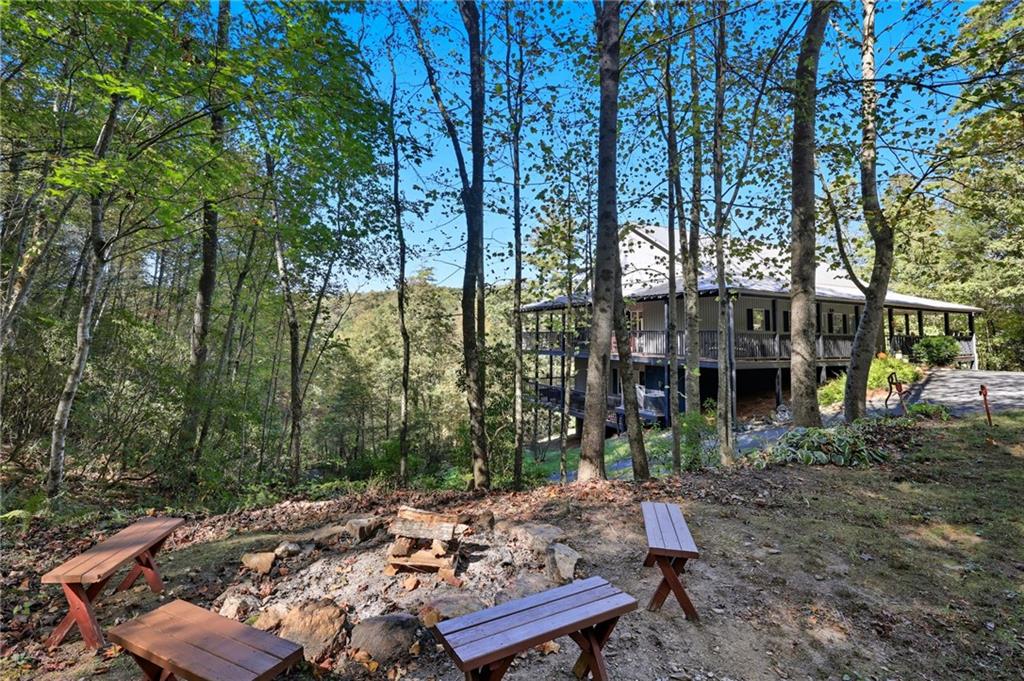 136 Ross Road Mineral Bluff, GA 30559 - Photo 30 of 65 a view of a wooden deck with chairs and a yard