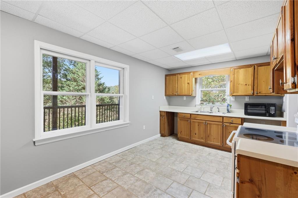 136 Ross Road Mineral Bluff, GA 30559 - Photo 34 of 65 a kitchen with stainless steel appliances granite countertop a stove cabinets and a kitchen island