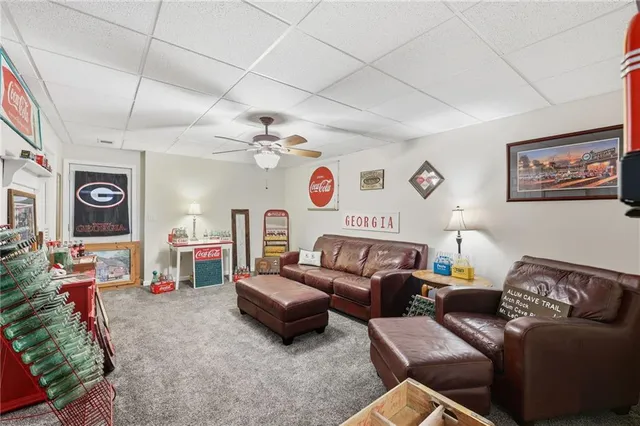 a bedroom with a bed chandelier and a window