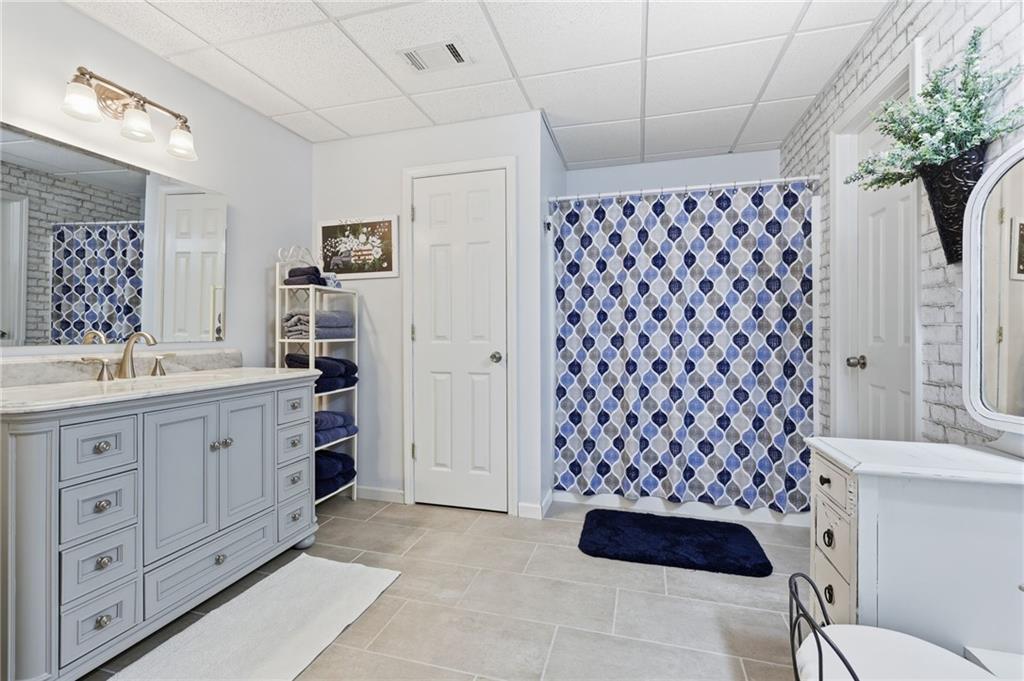 136 Ross Road Mineral Bluff, GA 30559 - Photo 40 of 65 a bathroom with a sink a toilet a mirror a vanity and shower