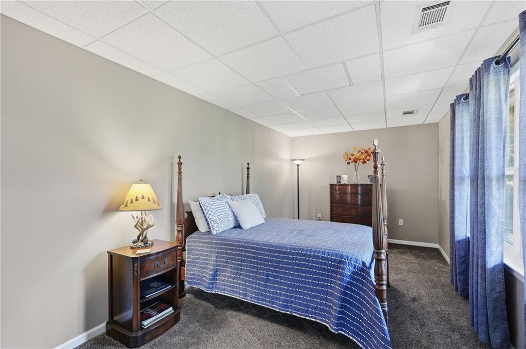 136 Ross Road Mineral Bluff, GA 30559 - Photo 41 of 65 a bedroom with a bed and a chandelier