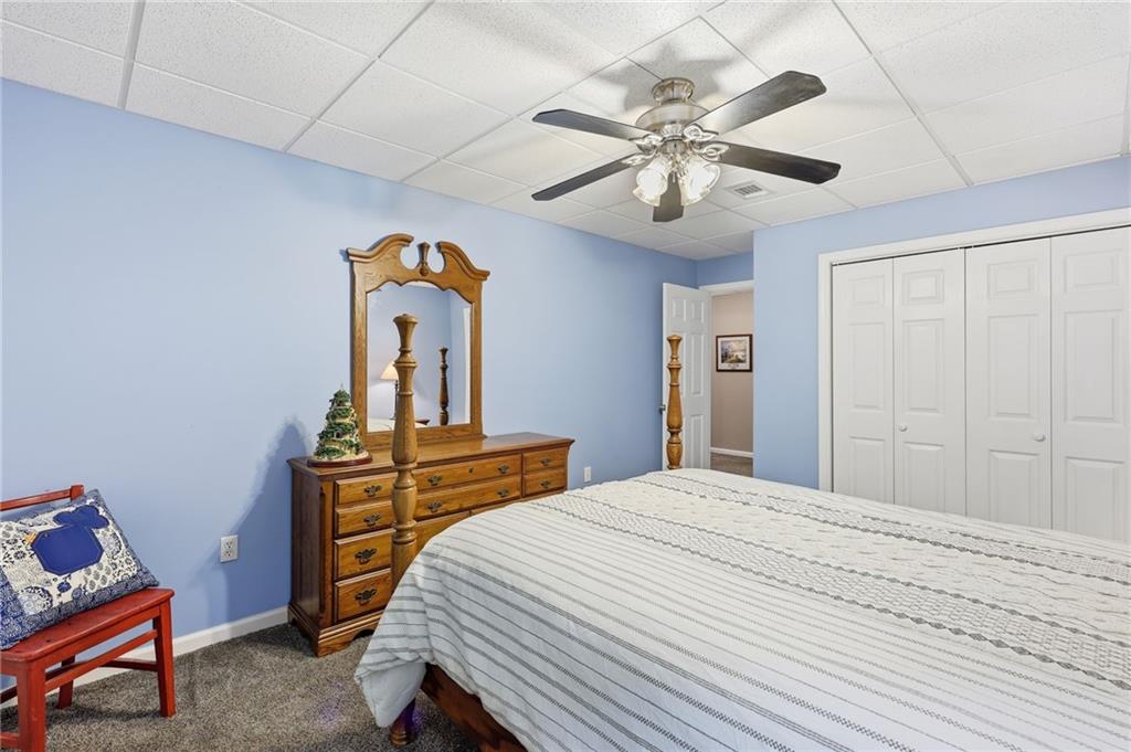 136 Ross Road Mineral Bluff, GA 30559 - Photo 44 of 65 a bedroom with a bed and a chandelier