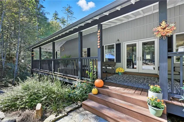 a living room with furniture chandelier and large windows