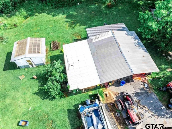 an aerial view of residential house with outdoor space and trees