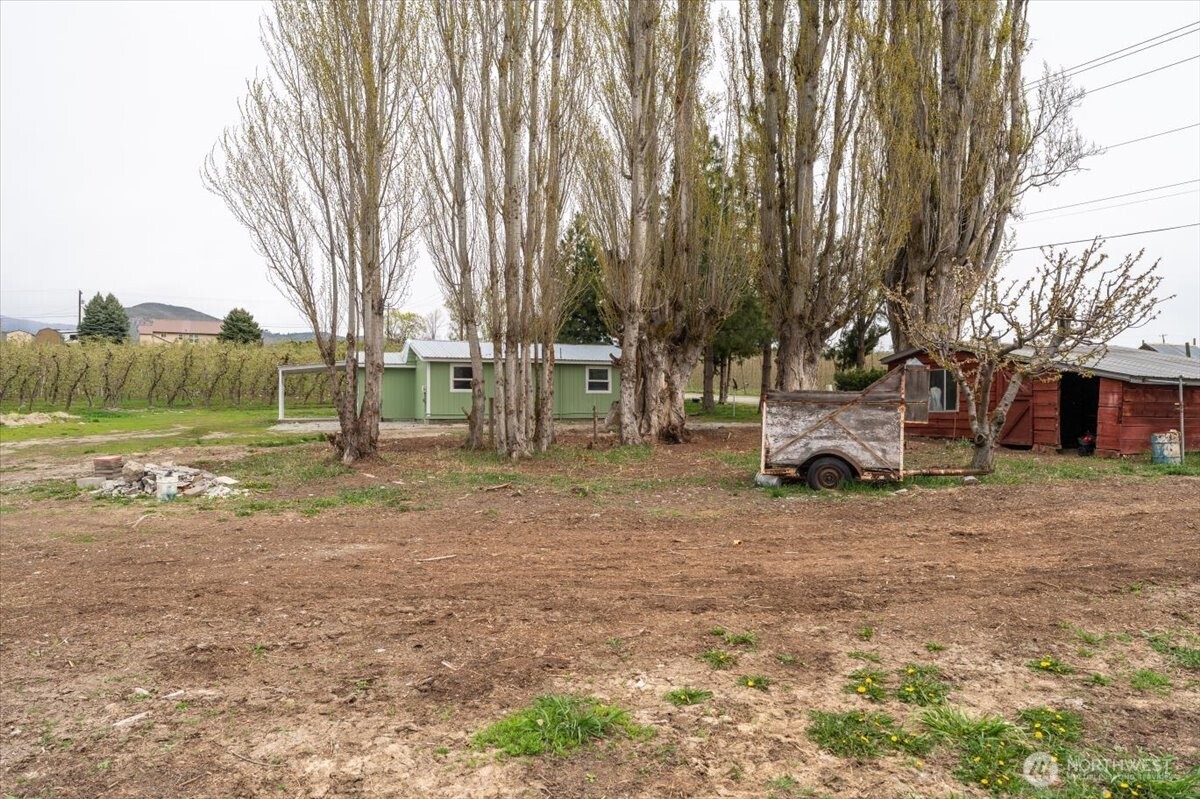 293 Barkley Road Manson, WA 98831 - Photo 33 of 40 a view of a yard with a house and a park