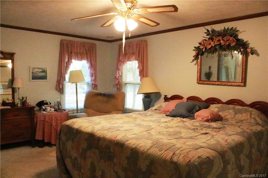 1262 Stateline Road Lake Wylie, SC 29710 - Photo 14 of 20 a bedroom with a bed and a chandelier