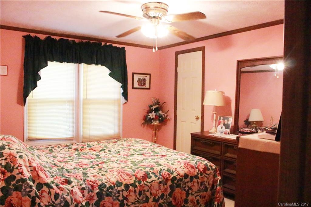 1262 Stateline Road Lake Wylie, SC 29710 - Photo 18 of 20 a bedroom with a bed and a chandelier