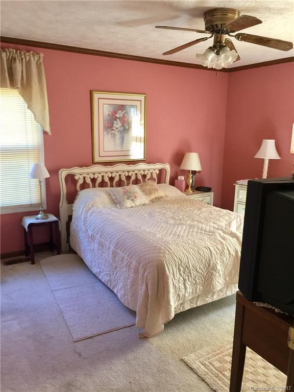 1262 Stateline Road Lake Wylie, SC 29710 - Photo 19 of 20 a bedroom with a bed and a chandelier