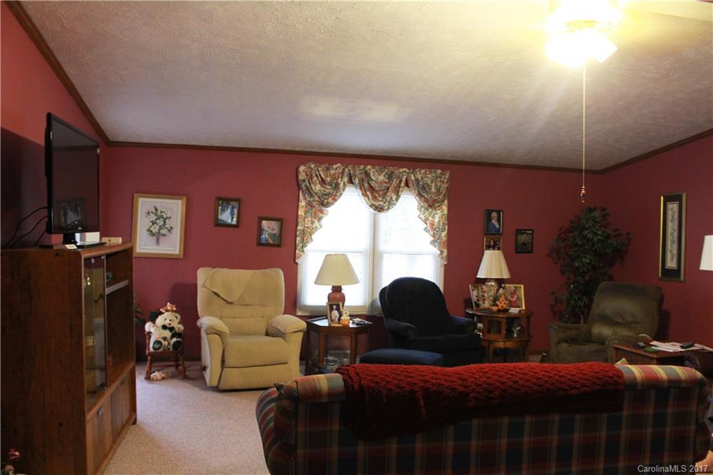 1262 Stateline Road Lake Wylie, SC 29710 - Photo 8 of 20 a living room with furniture a lamp and a large window