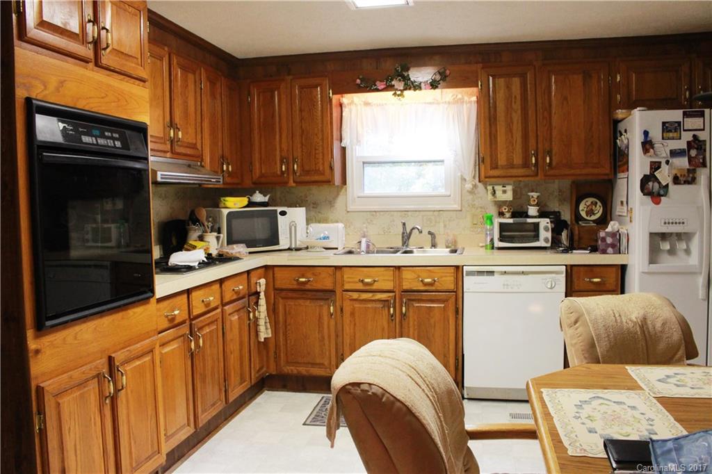 1262 Stateline Road Lake Wylie, SC 29710 - Photo 10 of 20 a kitchen with stainless steel appliances granite countertop a stove a sink dishwasher and a microwave oven with cabinets