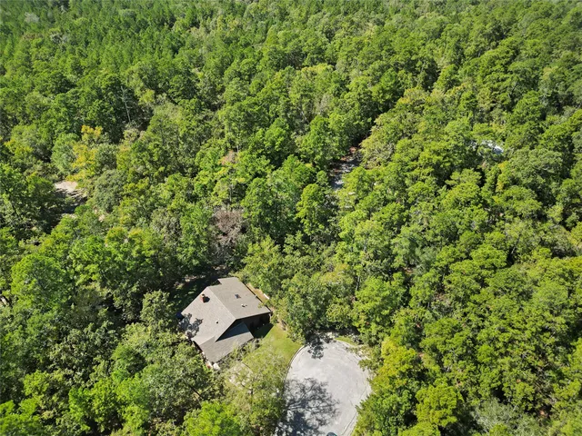 an aerial view of a house with a yard and outdoor space