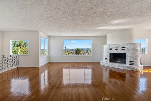 a view of open kitchen with window and fireplace
