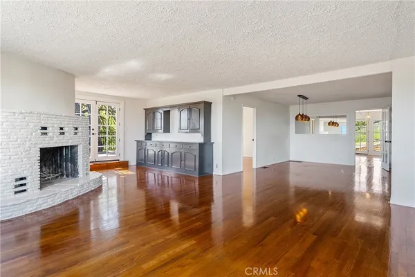 a view of a living room with furniture and a fireplace