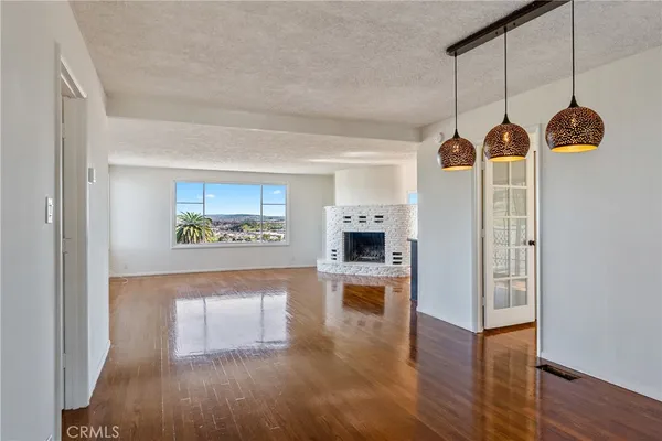 a view of a living room with hardwood floor and a ceiling fan