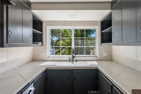 a kitchen with a sink and large window