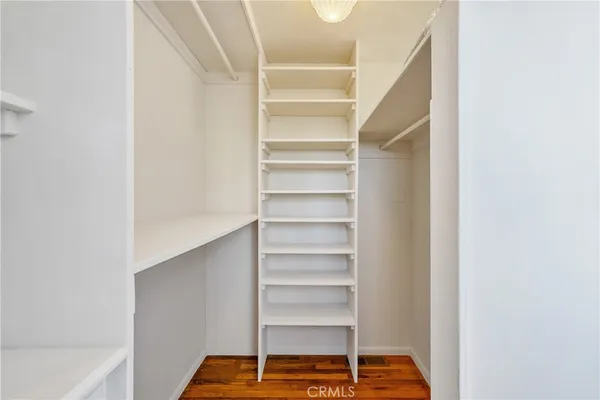 a view of walk in closet with empty racks