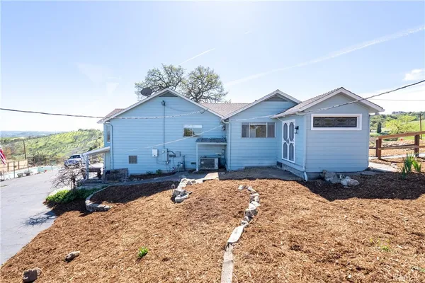 a front view of a house with a yard covered in snow