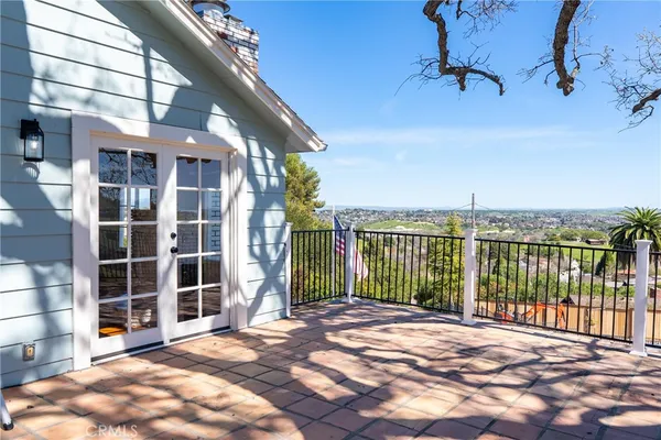a view of a balcony with a floor to ceiling window and wooden fence