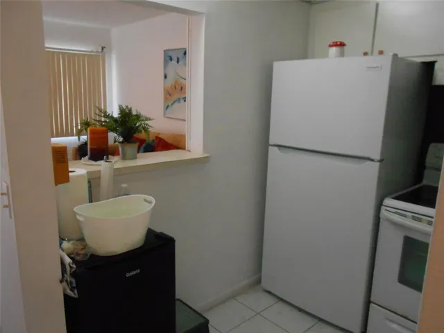 a white refrigerator freezer sitting inside of a kitchen