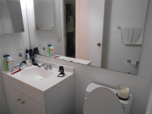a bathroom with a sink vanity and mirror