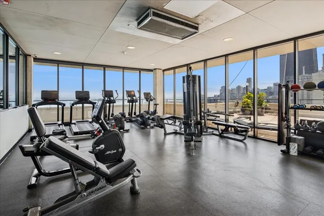 a view of a room with lots of chairs and large windows