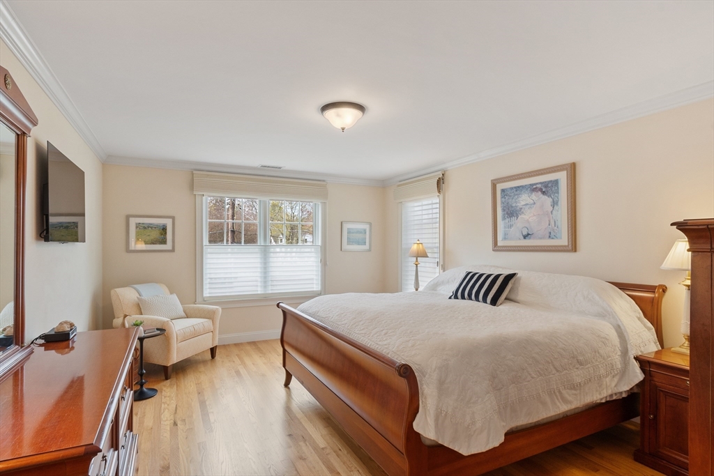 27 Maxwell Road Bedford, MA 01730 - Photo 14 of 41 a bedroom with a bed and wooden floor