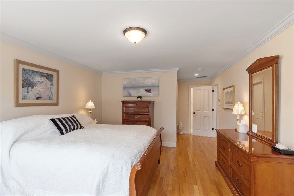 27 Maxwell Road Bedford, MA 01730 - Photo 15 of 41 a spacious bedroom with a bed and wooden floor