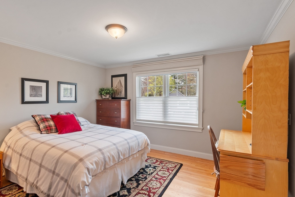 27 Maxwell Road Bedford, MA 01730 - Photo 20 of 41 a bedroom with a bed and wooden floor