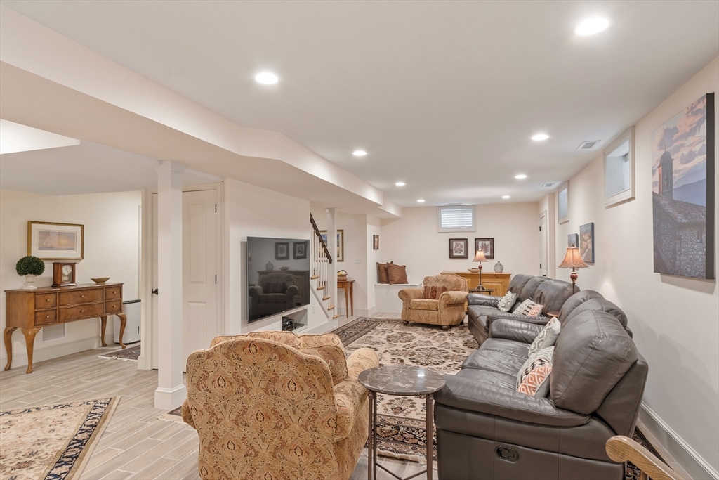27 Maxwell Road Bedford, MA 01730 - Photo 21 of 41 a living room with furniture and a flat screen tv