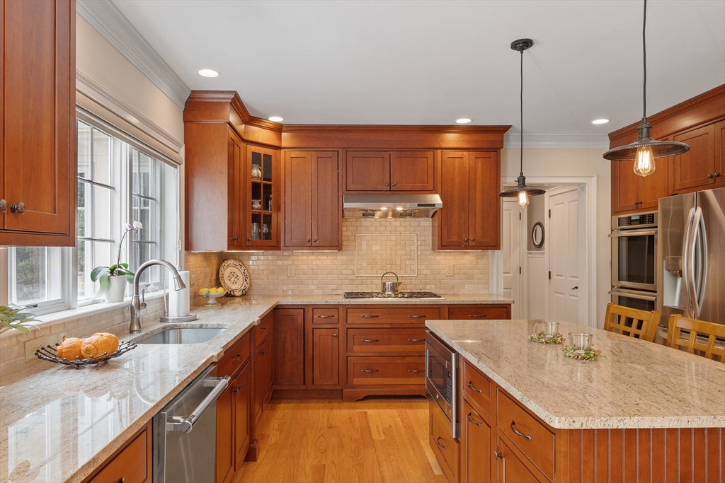 27 Maxwell Road Bedford, MA 01730 - Photo 4 of 41 a kitchen with stainless steel appliances a sink stove and refrigerator