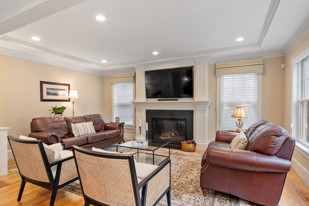 27 Maxwell Road Bedford, MA 01730 - Photo 7 of 41 a living room with furniture a flat screen tv and a fireplace