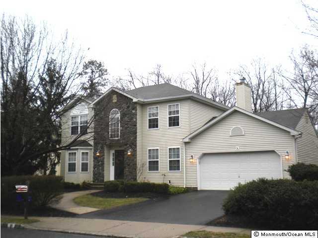 10 Sun Hollow Road Howell, NJ 07731 - Photo 1 of 3 a view of a white house next to a road and yard