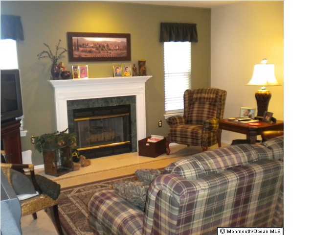 10 Sun Hollow Road Howell, NJ 07731 - Photo 3 of 3 a bedroom with furniture and a fireplace