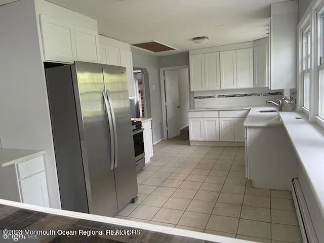 a kitchen with stainless steel appliances a refrigerator and a sink