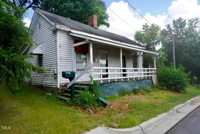 a front view of a house with a yard table and chairs