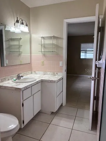 a bathroom with a sink a toilet and mirror