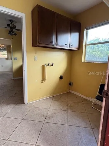 a view of a kitchen with wooden cabinets