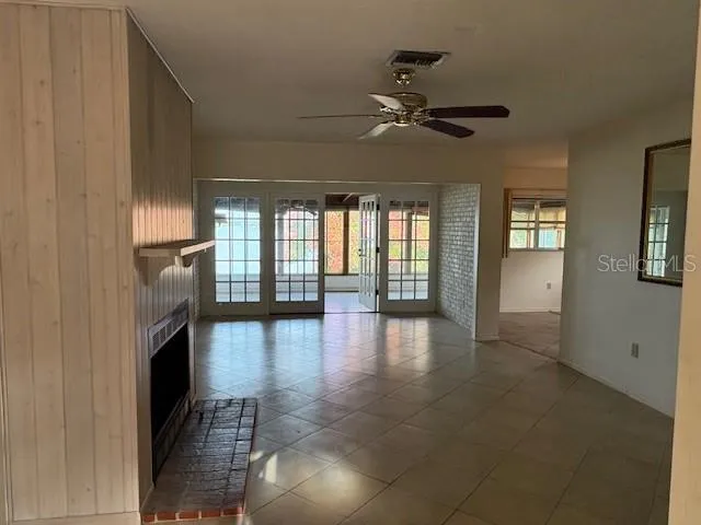 wooden floor in an empty room with a fireplace