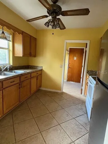 a view of a kitchen with a sink and a refrigerator
