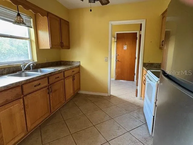 a kitchen with a sink and a refrigerator