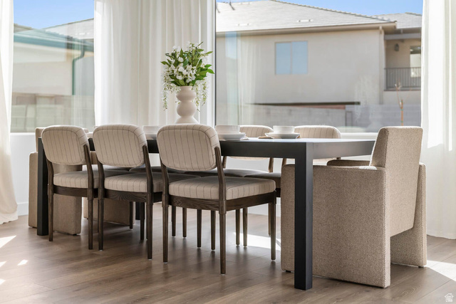 352 North Rhyolite Drive, Unit 89 Hurricane, UT 84737 - Photo 31 of 41 Dining area featuring wood-finish flooring, full-height windows with sheers, and a contemporary dining table